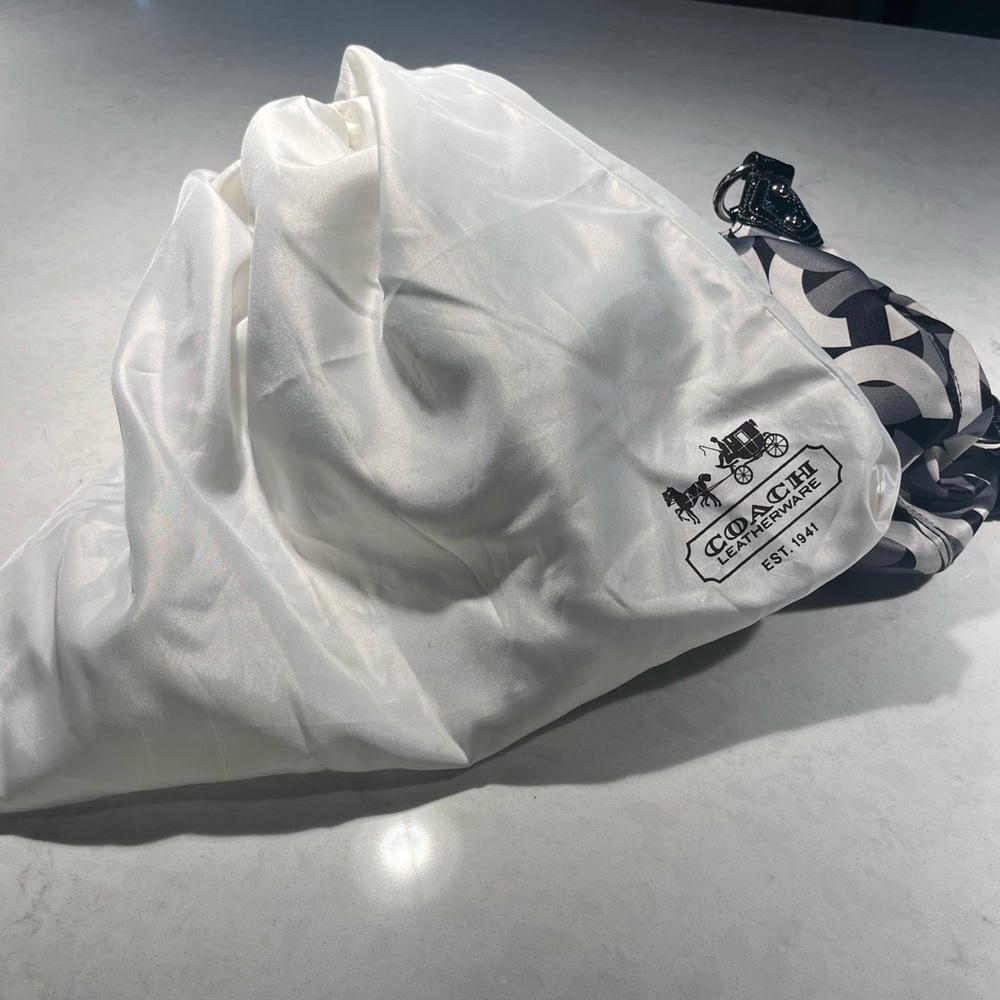 Coach handle bag. Black and white, purple interior.